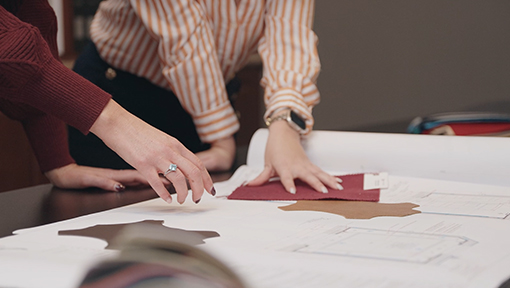 The Design Service Program Two people look at schematics designed by CinemaTech's Design team.