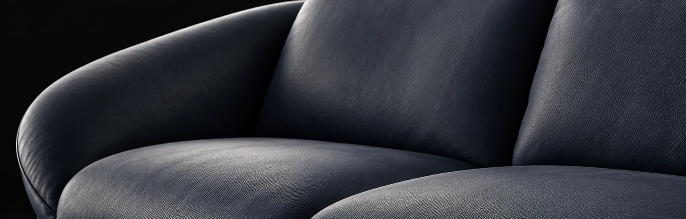 Montecito Home Theater Seating - Navy Upholstery Detail Navy Montecito home theater seating with a rounded arm, cushioned back, and seat